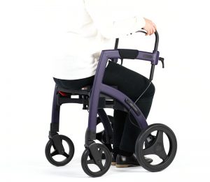 Woman showing how to sit on a rollator with seat