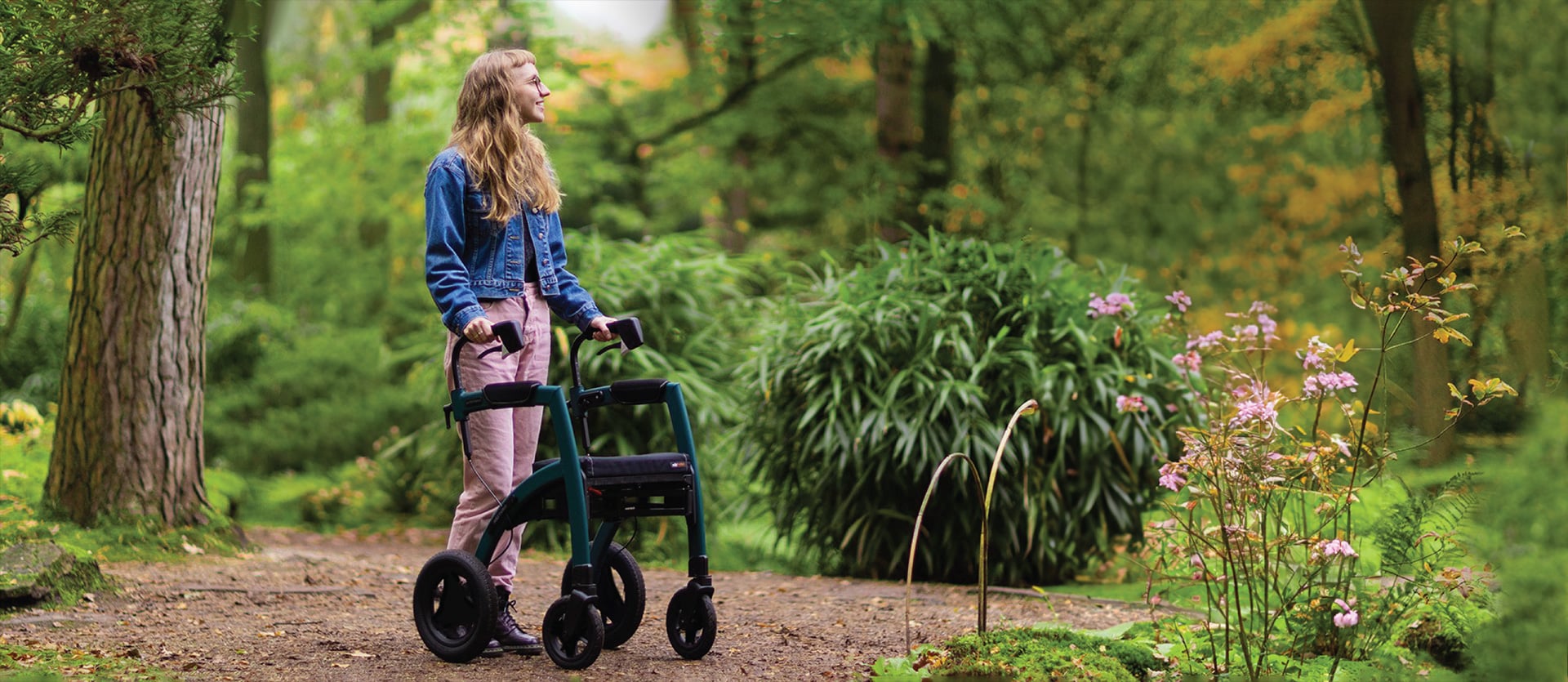 Woman walking with a rollator with Rollz Fit accessory